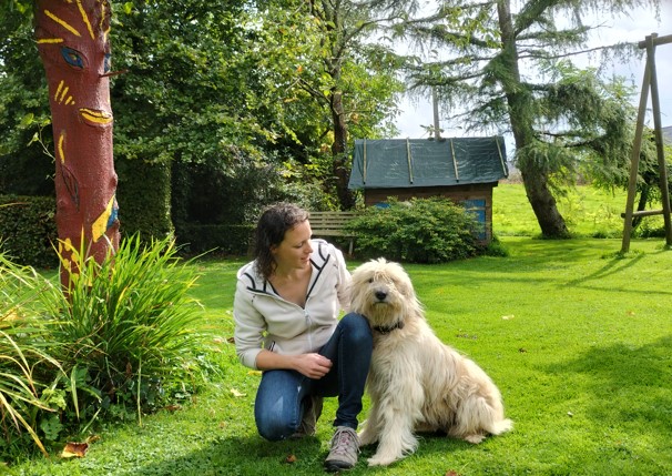 Hélène et sa chienne, complices, dans le jardin.